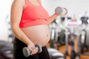 Pregnant Woman Working Out With Dumbbells